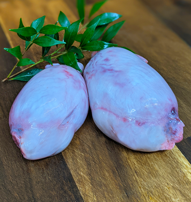 Front view of two raw goat testes for raw feeding diets for dogs and puppies. Excellent raw meal additions for male stud dogs.